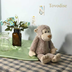 Tovodise plush monkey toy, cuddly companion for bedtime routines and imaginative play.