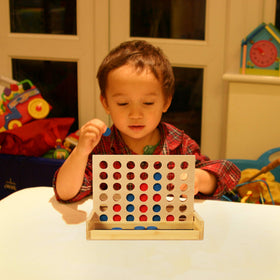 TOWO wooden 4-in-a-row discs drop with satisfying click.