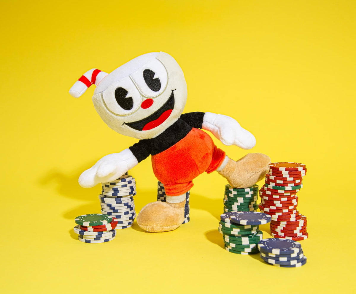 Toynk Cuphead 8-inch plush sitting on bed demonstrates ready-to-display desk companion.