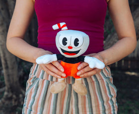 Toynk Cuphead 8-inch plush in hand showcases comfortable grip for travel.