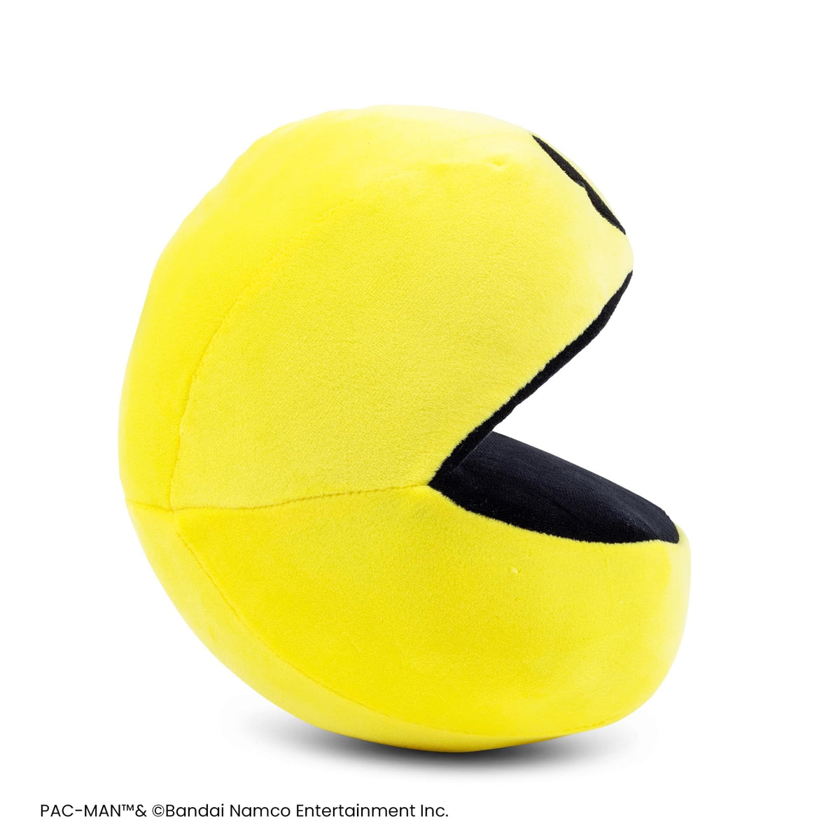 Toynk Pac-Man 7-Inch Plush lounging on a bed adds a cute gaming room accent.