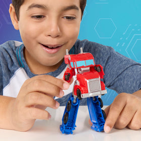 Transformers EarthSpark Optimus Prime 5-inch action figure in dynamic pose for playsets.