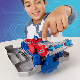 Transformers EarthSpark Optimus Prime vehicle rolls with trailer for portable playtime.