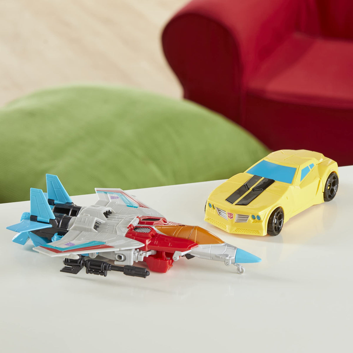 Transformers play scene captures kids imagining Autobots vs Decepticons with Bumblebee and Starscream.
