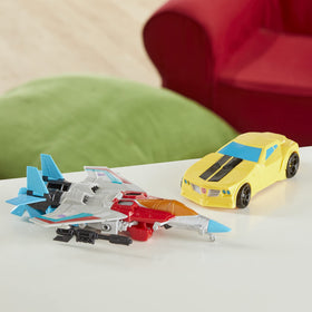 Transformers play scene captures kids imagining Autobots vs Decepticons with Bumblebee and Starscream.