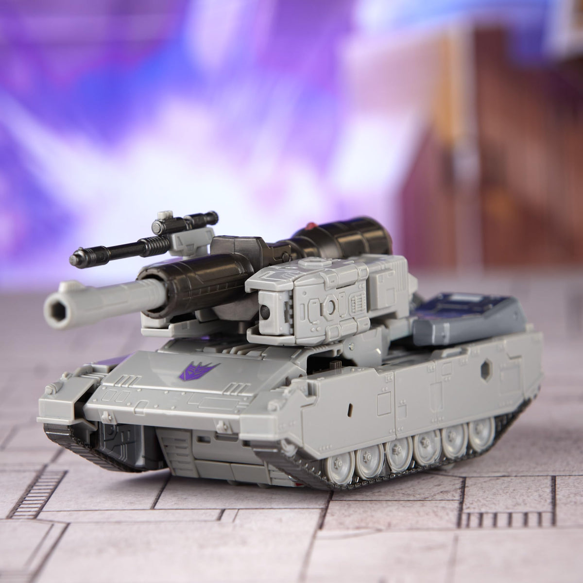 Megatron saber accessory shown with action figure in dynamic stance.