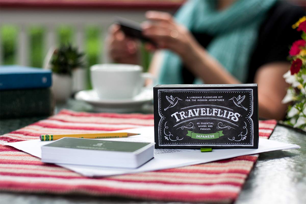 Learner flipping Travelflips cards in a real-life travel scene