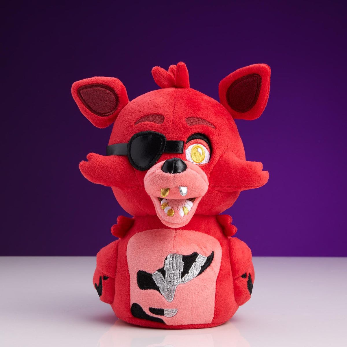 TUBBZ Foxy plush with weighted base standing upright on a desk