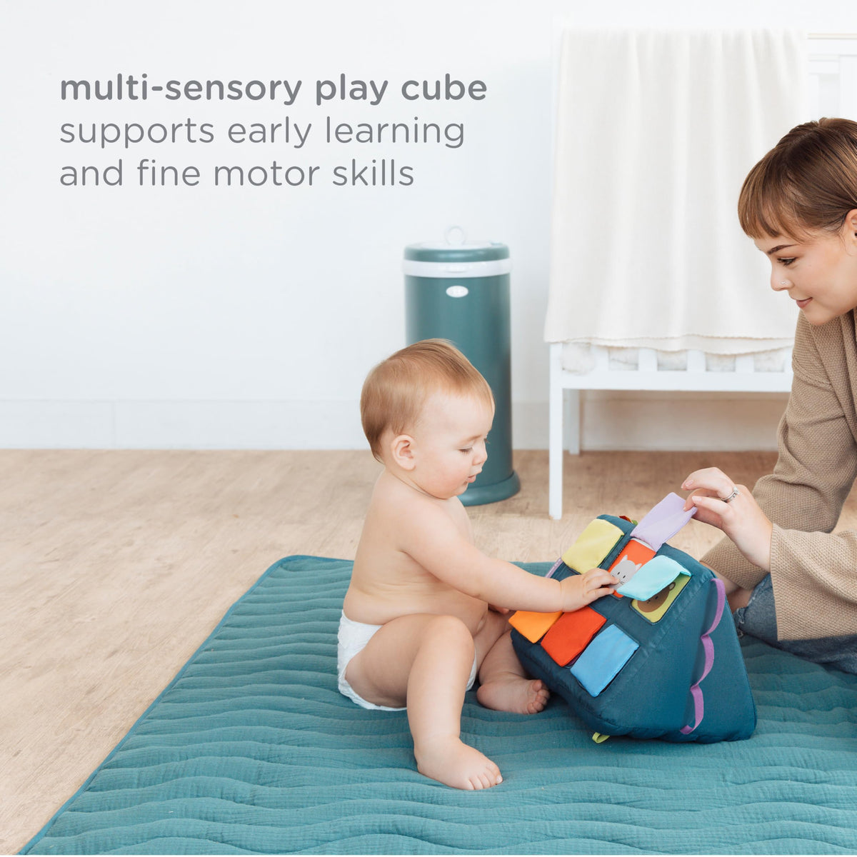 Ubbi Mirror Me Cube wave-textured side offers varied tactile stimulation