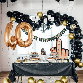 UNIIDECO Middle Finger Pinata on table, perfect for 30th–60th birthday celebrations