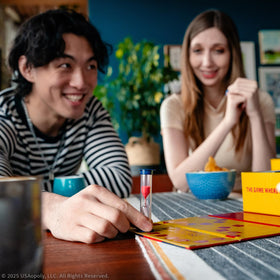 USAOPOLY 25 Words or Less card play shows bidding and clues in action