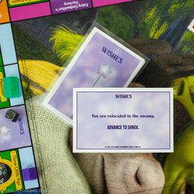 USAOPOLY MONOPOLY Shrek Edition game board highlights vibrant Far Far Away scenery