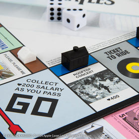 USAOPOLY Beatlemania cards spark surprise effects during turns.