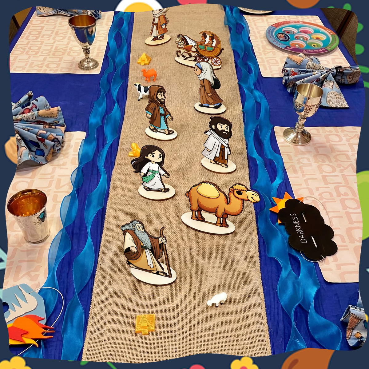 Vicenpal Passover set Moses model complements blue gauze and linen runner.