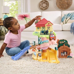 VTech Bluey Road Trip Playset: gas station stop with Uncle Stripe boosts pretend travel.