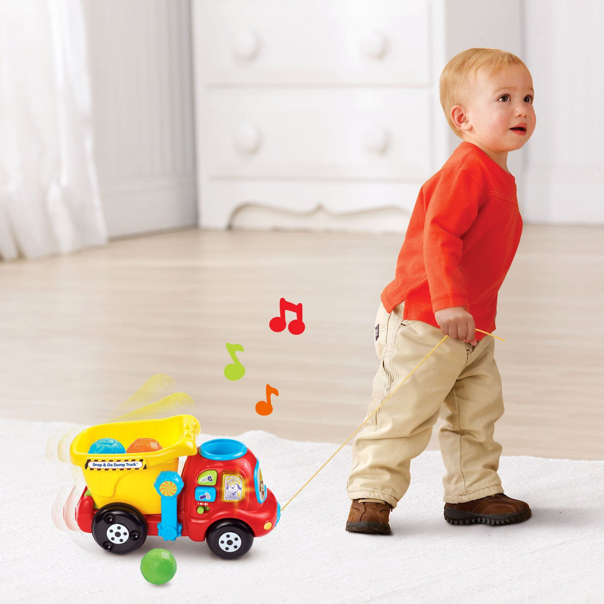 VTech Drop and Go Dump Truck yellow being pushed along supports motor skills