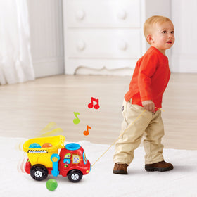 VTech Drop and Go Dump Truck yellow being pushed along supports motor skills