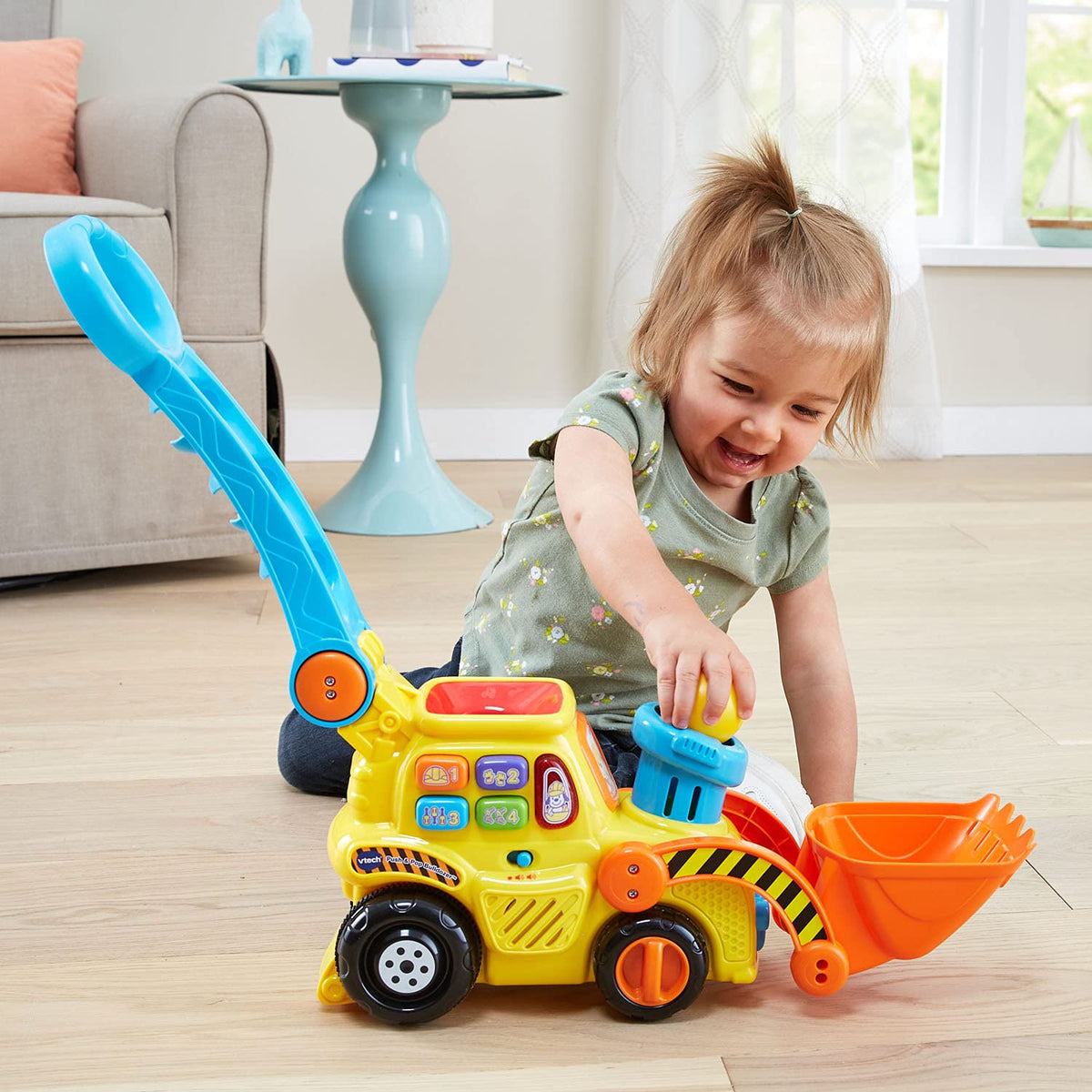 VTech Pop-a-Balls Bulldozer yellow design stands out on the playroom floor.