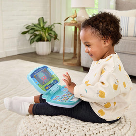 VTech Swipe and Learn Smarties Laptop surprise button adds playful sounds.