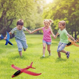 Vyndicca foam airplane used outdoors with family at a park or beach.
