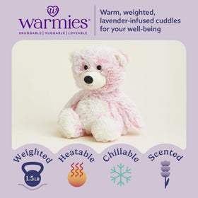 Warmies pink bear being warmed for soothing comfort.
