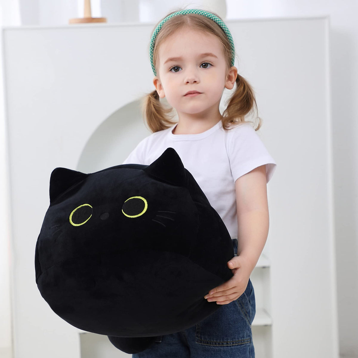WeBingo black cat plush on bed used as a cozy pillow for relaxation.