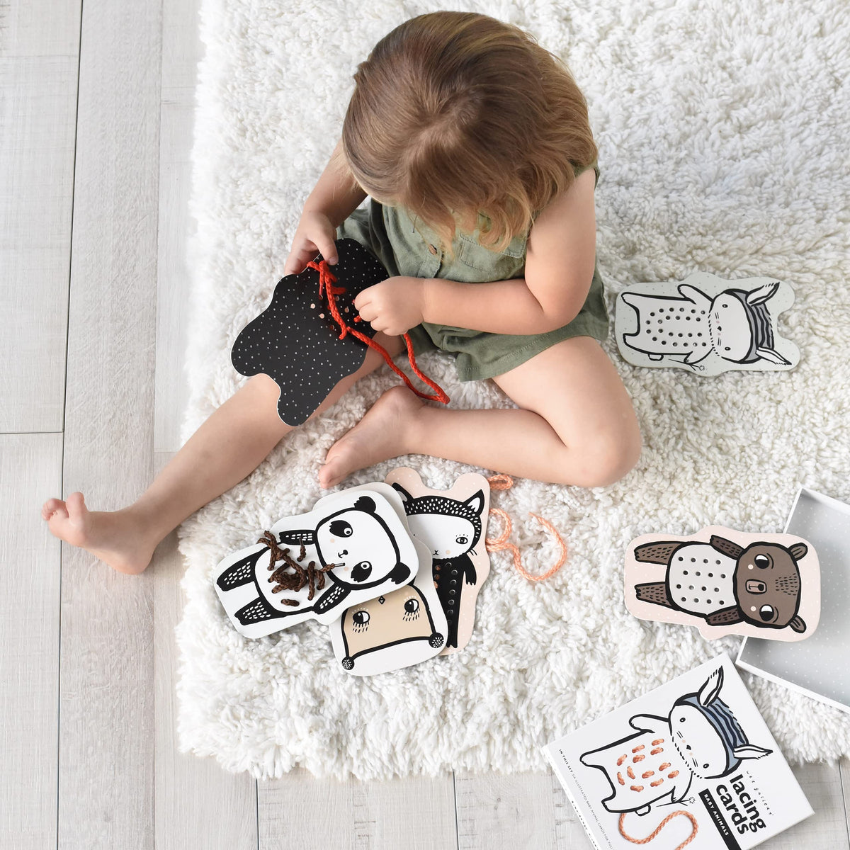Wee Gallery Baby Animals lacing cards with imaginative designs invite curious kids to practice lacing