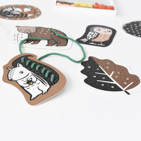 Wee Gallery Woodland Lacing Cards used as a travel activity for kids.