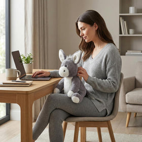 WEIGEDU gray donkey plush on bed as a cozy bedtime companion.