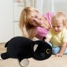 WePop black cat plush in a cozy bedroom corner evokes soft nighttime comfort