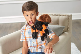 Wild Republic tarantula plush on a couch during movie night.