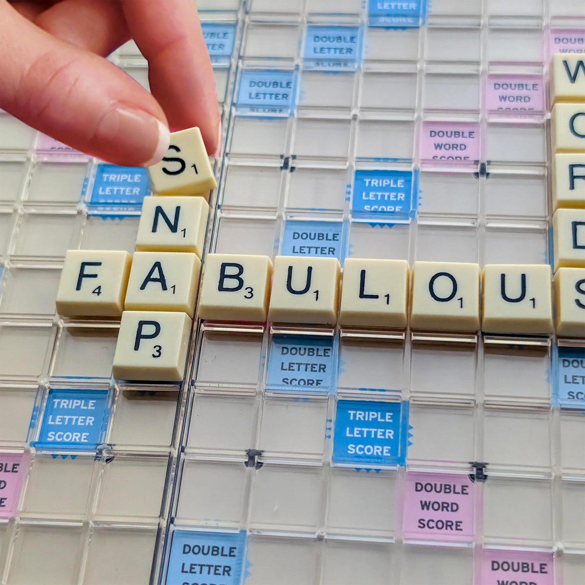 Winning Moves Scrabble To Go tile-racks with privacy shields help mid-game storage.