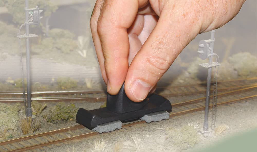 Woodland Scenics Tidy Track Rail Tracker Kit close-up on rails for visibility of grime