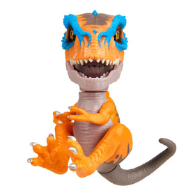 WowWee Scratch Orange Untamed T-Rex gripping claws hold securely on a finger