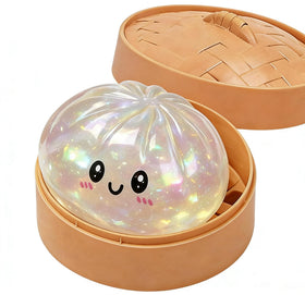 Xihongshi Glitter Dumpling Box squishy in a steamer basket for gentle stress relief.