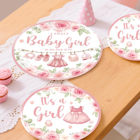 Xynic 7-inch pink plates hold snacks with sturdy paper.
