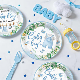 Xynic baby shower tablecloth protects surfaces with greenery decor.