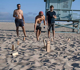 Yard Games Kubb playing scene shows friends enjoying outdoors