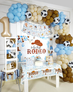 YJDFWAUT Cowboy cake topper and table cloth unify dessert and dining area.