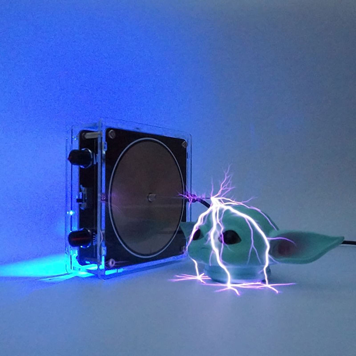 Yoqanr coil powers wireless demonstrations with music-driven sparks and wireless energy display.
