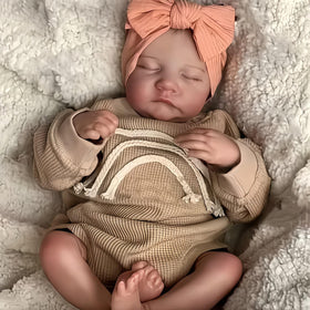 YuDill doll dressed in baby clothes for a gift-ready look.