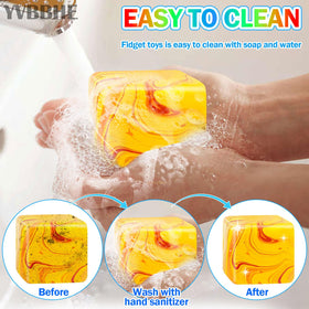 YVBBHE orange fidget cube in hand demonstrating slow-rise calming action.
