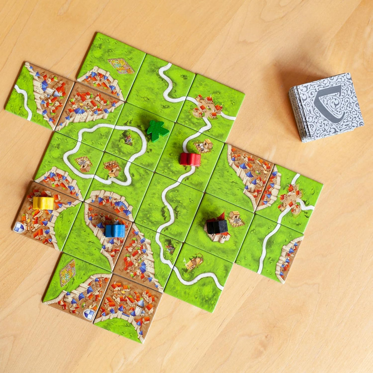 Z-Man Games Carcassonne illustrated tiles featuring vibrant medieval artwork.