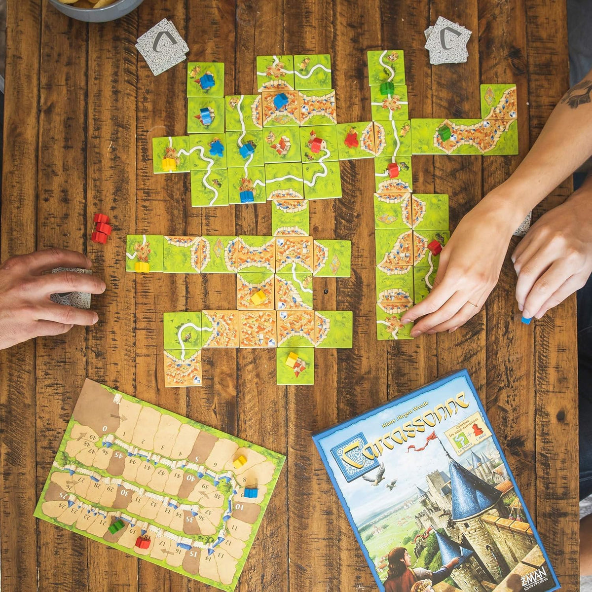 Z-Man Games Carcassonne meeples placing image showing strategic tile placement.