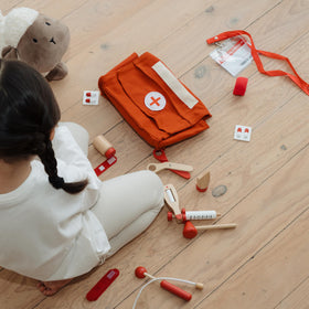 Bright red ZICOTO doctor set captivates toddlers during play