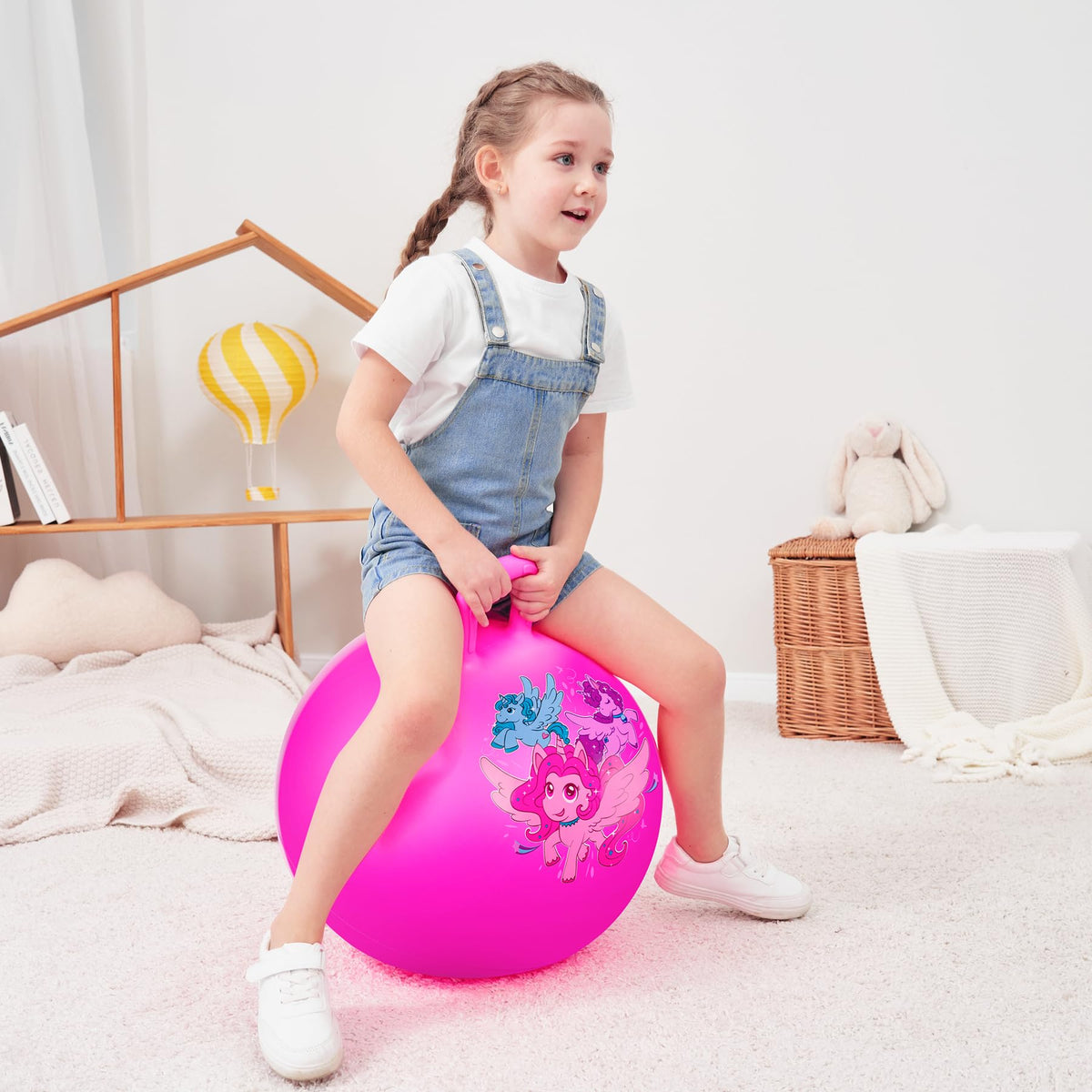 Unicorn prints and pink design appeal to young riders.